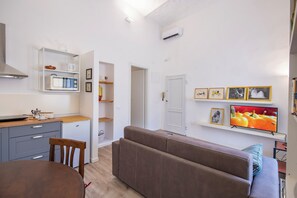 Apartment | Living area | 24-inch flat-screen TV with digital channels - Mamo Florence - Borgo Santa Croce Apartment (Florence)