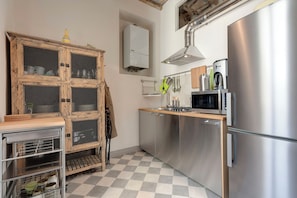 Apartment | Private kitchenette | Full-size fridge, microwave, stovetop, dishwasher