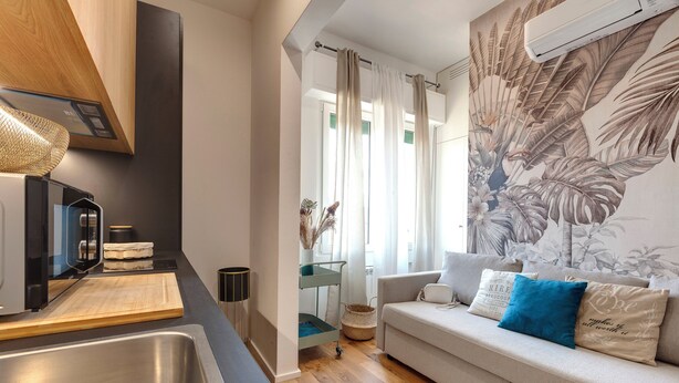 A modern kitchen with a stainless steel sink, wooden countertop, and a built-in oven. - Mamo Florence - Guido Monaco Apartment (Florence)