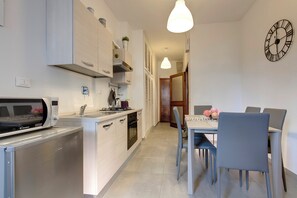 Apartment | Private kitchenette | Full-size fridge, microwave, stovetop, electric kettle - Mamo Florence - Lungarno Apartment (Florence)