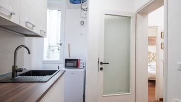 Apartment | Private kitchenette | Full-size fridge, microwave, stovetop, dishwasher
