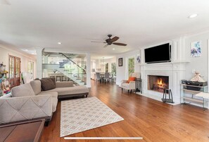 Smart TV, fireplace, books, computer monitors