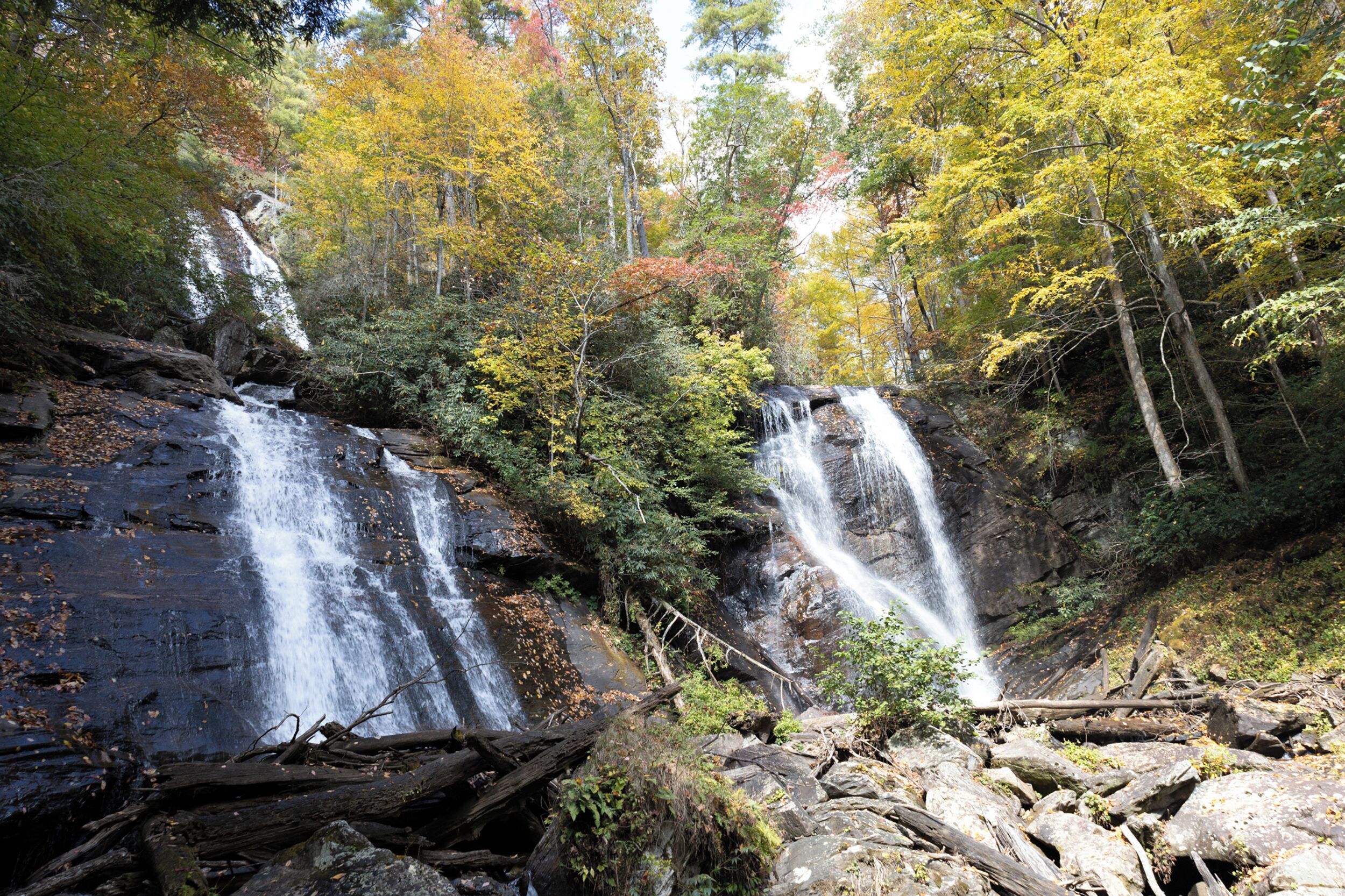 A waterfall surrounded by autumn foliage.