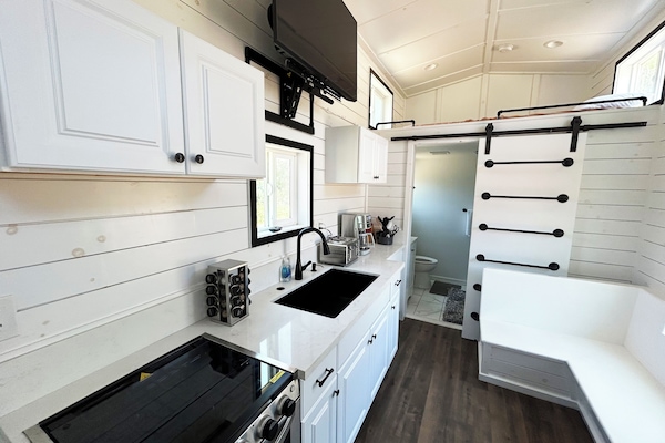 Full kitchen with sink, stove, refrigerator, coffee maker, and a great view