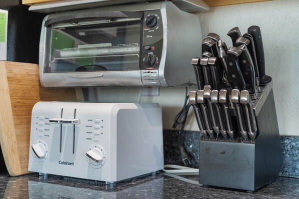 A kitchen with a toaster and a knife block.