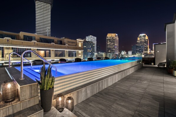 A heated pool - Stay Near French Quarter – Stylish Suites with Rooftop Amenities! (New Orleans)
