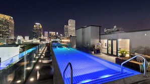 A rooftop pool with a city skyline in the background.