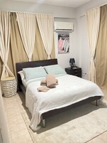 Cubrecamas y tabla de planchar con plancha 