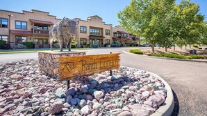 A ranch-style building with a sign reading "The Ranch Condos" in front. - Condo at Bison Ranch with Resort Amenities (Overgaard)