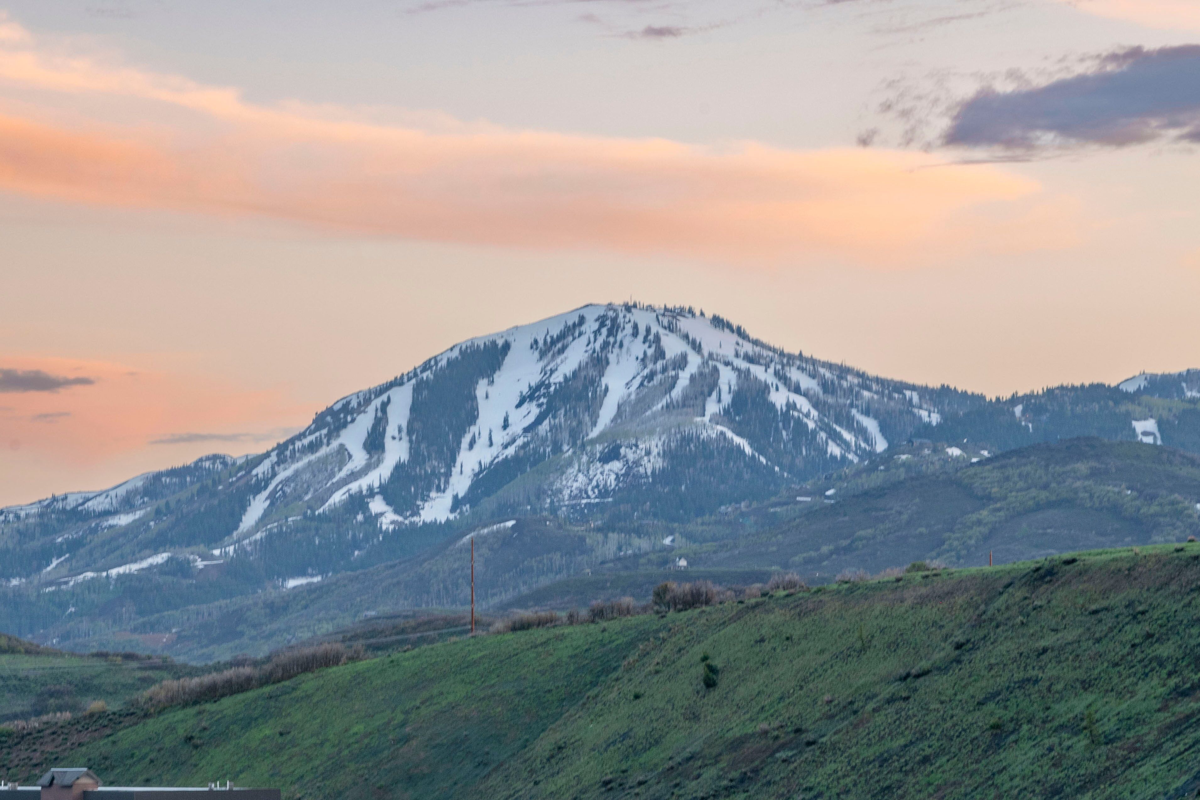 A mountain with snow-capped peaks and a clear sky.