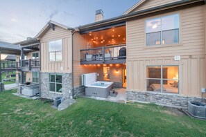 A two-story house with a balcony, a hot tub, and a covered outdoor seating area. - Black Rock Ridge by Luxury Mountain (Heber City)