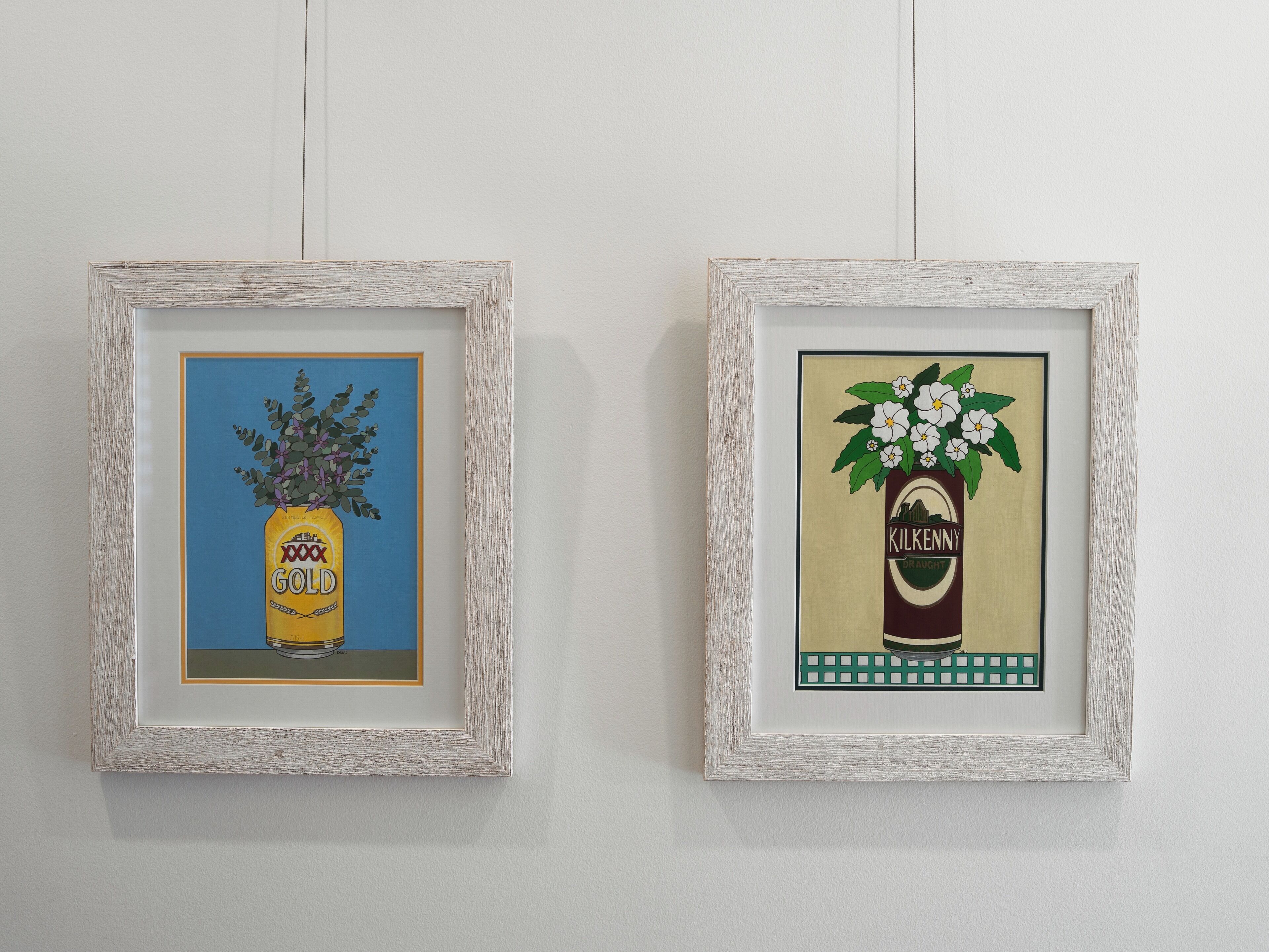 Two framed artworks on a wall.