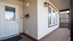 A wooden porch with a white door, a mailbox, and a decorative lantern. - Celest Homes! Spacious, family home, right  for your next family adventure.  (Edmonton)