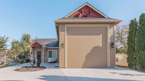 A single-story house with a beige garage door and a red roof.