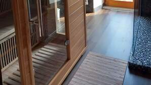 A modern interior with a sliding glass door leading to a balcony, a wooden floor, and a visible staircase. - Casa Mazzagno Room with Wi-Fi (Comelico Superiore)