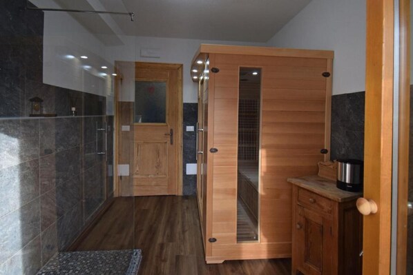 A modern kitchen with wooden cabinets, a countertop, and a coffee maker.
