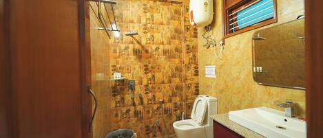 A bathroom with patterned tiles, a toilet, a sink, and a mirror.