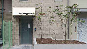 A building with a sign reading "mangrove" above the entrance.