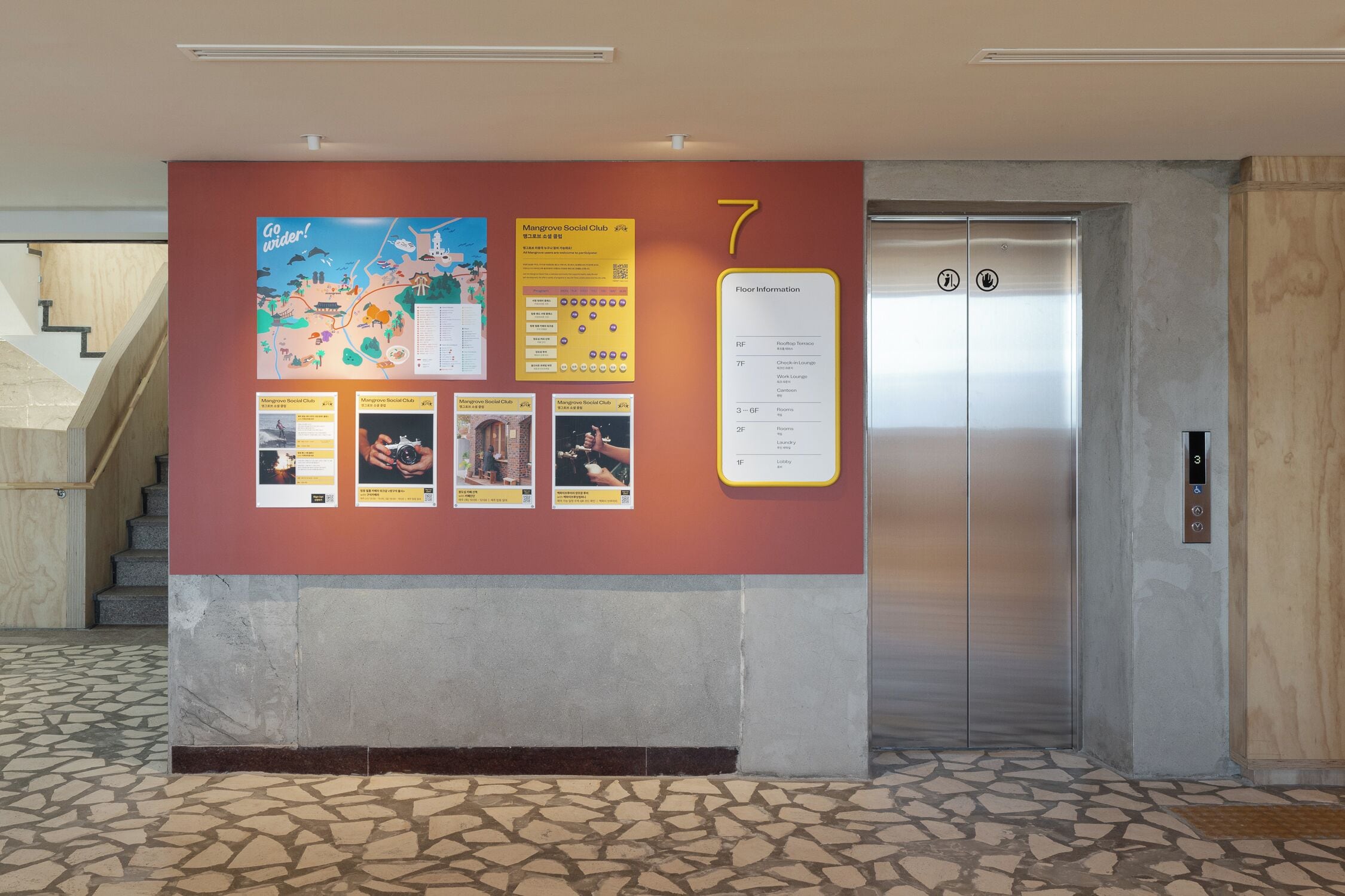 A wall with a map, floor information, and a number 7 sign near an elevator.