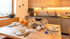 A modern kitchen with wooden cabinets, a microwave, and a coffee maker on the counter.