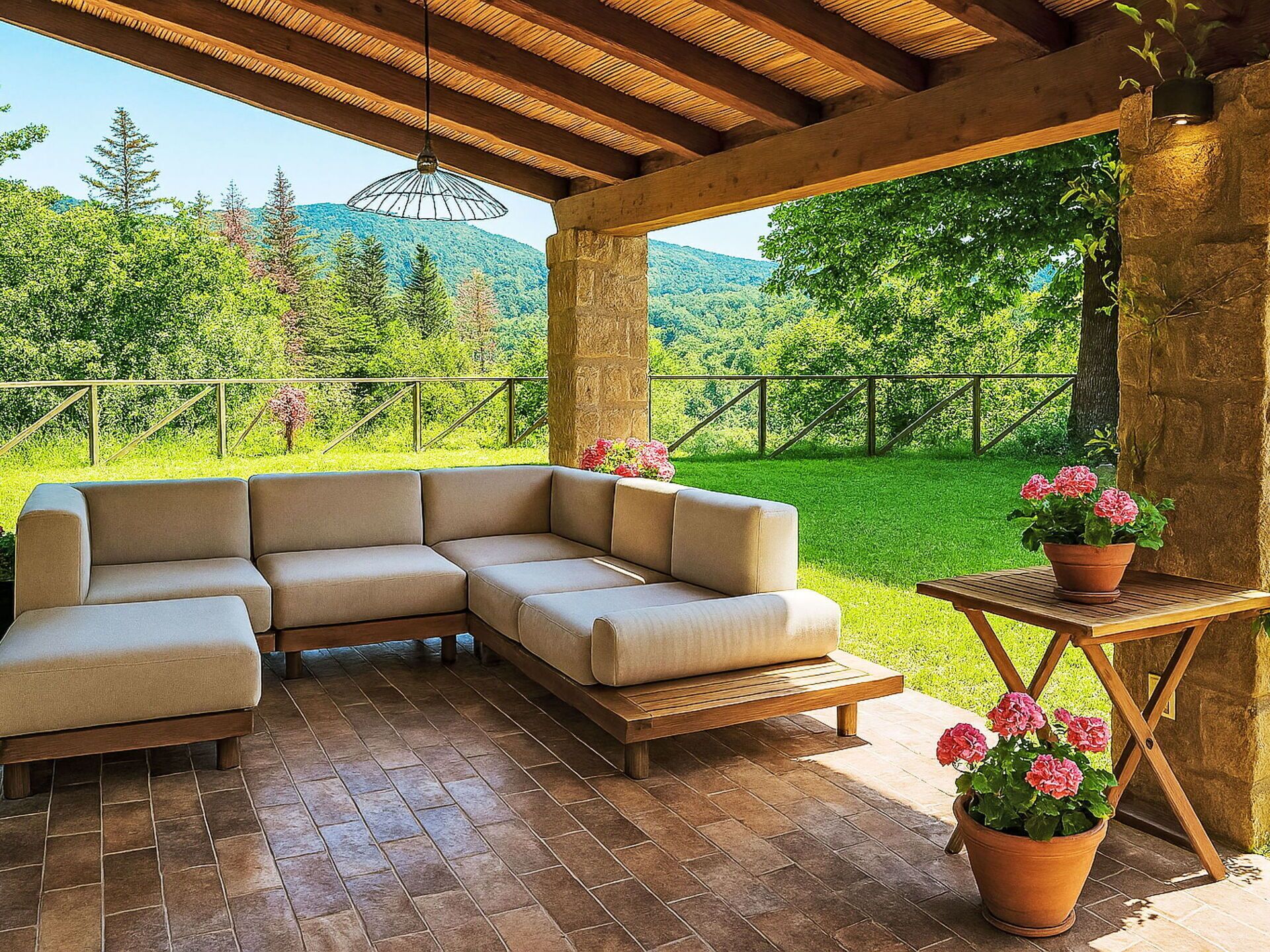 A covered outdoor seating area with a sectional sofa, a wooden table, and potted plants.