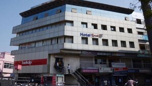 A multi-story hotel with a modern design, featuring a prominent 'Hotel Royal' sign. - Hotel Royal Apple (Ahmedabad)