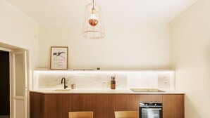 A modern kitchen with a wooden island, a marble countertop, and a pendant light. - Lovely apartment for 4 guests with A/C, WIFI (Rome)