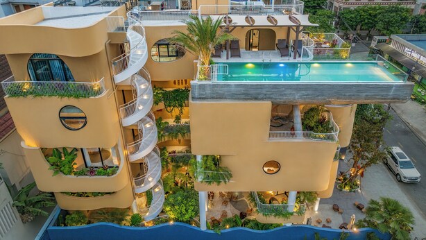 A multi-story hotel with a pool, outdoor seating, and balconies. - Saha Casa Boutique Hotel Da Nang (Da Nang)