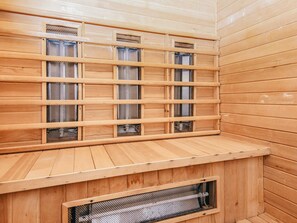 A sauna with wooden walls and benches. - 4 Star Holiday Home in Ulfborg (Ulfborg)