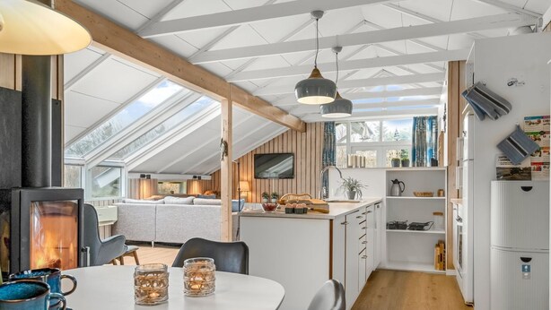 A modern kitchen with a central island, wooden beams, and a skylight. - "Wilmer" - 600m from the sea by Interhome (Løkken)