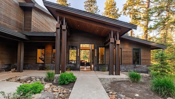 A modern house with a wooden exterior, a concrete pathway, and a stone border. - Golf Course View, Fire Pit & Suncadia Pool Access (Cle Elum)