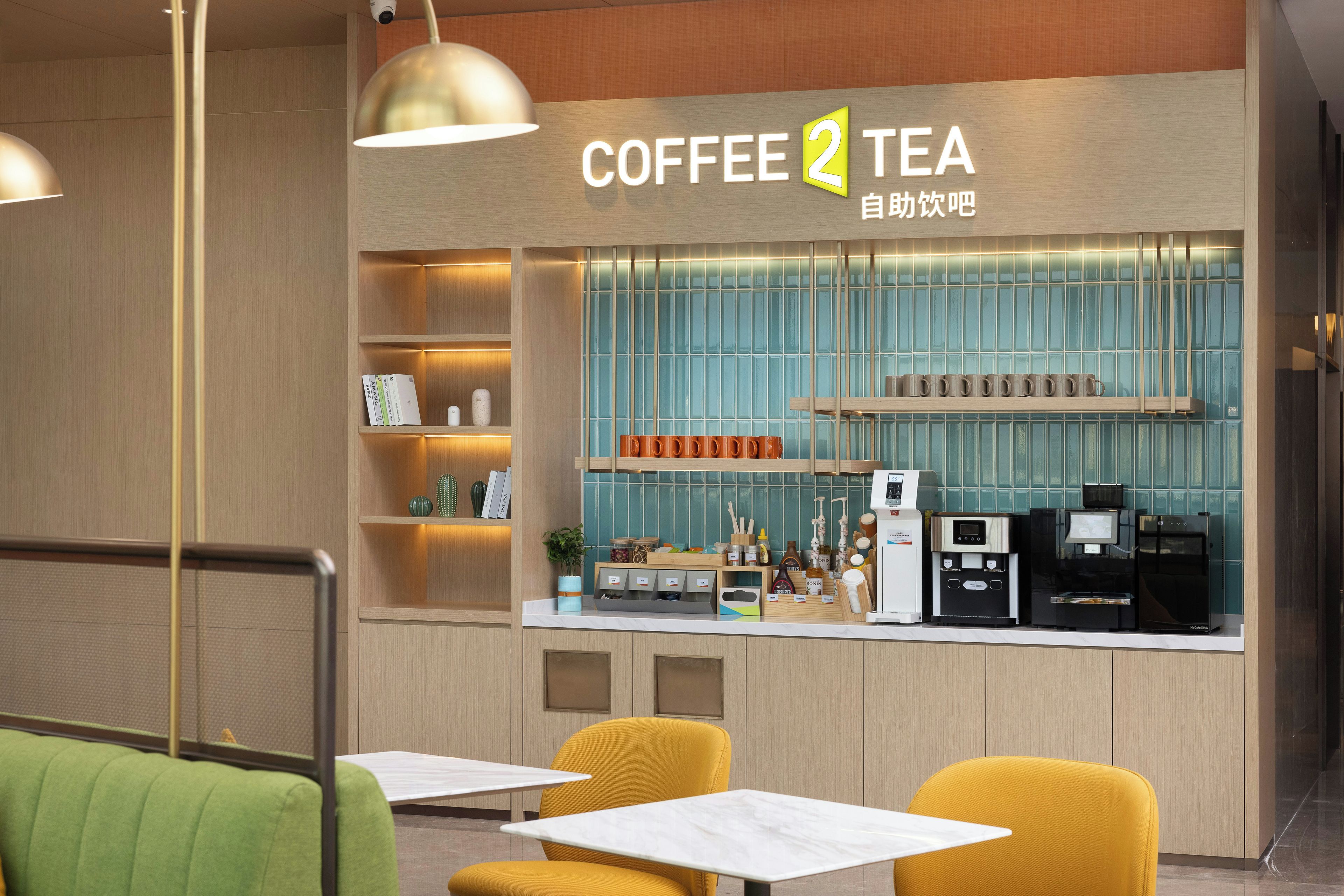 A coffee and tea shop with a counter, seating area, and various coffee machines.