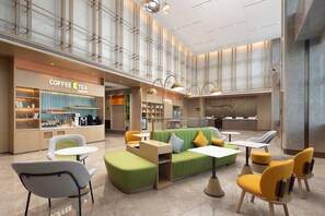 A modern coffee shop with seating areas, a counter, and a large windowed wall.