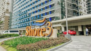 A modern hotel with a prominent 'Shore 3' sign, featuring a stylized wave design. - MOA Staycation 10mins to Airport. 10mins walk to iconic Mall of Asia. (Pasay)