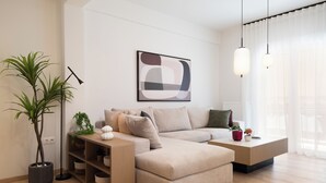 A modern living room with a sectional sofa, a coffee table, and a floor lamp.