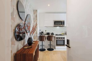 Microwave, stovetop, coffee/tea maker, cookware/dishes/utensils