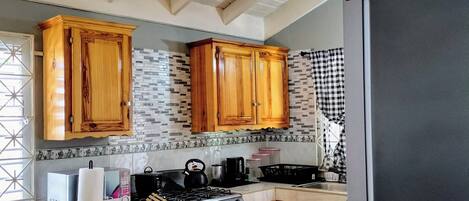 Fridge, microwave, stovetop, coffee/tea maker