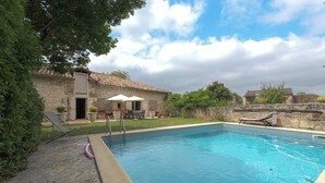 A swimming pool with a stone wall and a stone building in the background. - TARN, NEAR CORDES SUR CIEL, SMALL FAMILY CHATEAU WITH COTTAGE (Campagnac)
