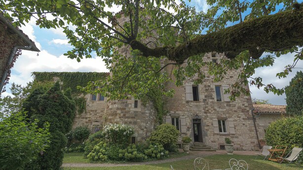 A stone building with a garden, outdoor seating, and a pathway leading to the entrance. - TARN, NEAR CORDES SUR CIEL, SMALL FAMILY CHATEAU WITH COTTAGE (Campagnac)