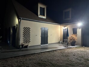 A house with a covered patio, a single door, and a small window.