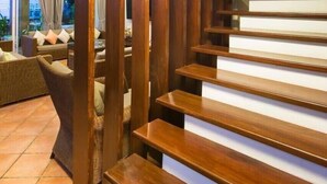 A staircase with wooden steps and a modern design, leading to an upper floor. - Aranava Resort Huahin (Hua Hin)