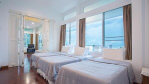 A hotel room with two beds, large windows, and a view of the sea. - Aranava Resort Huahin (Hua Hin)