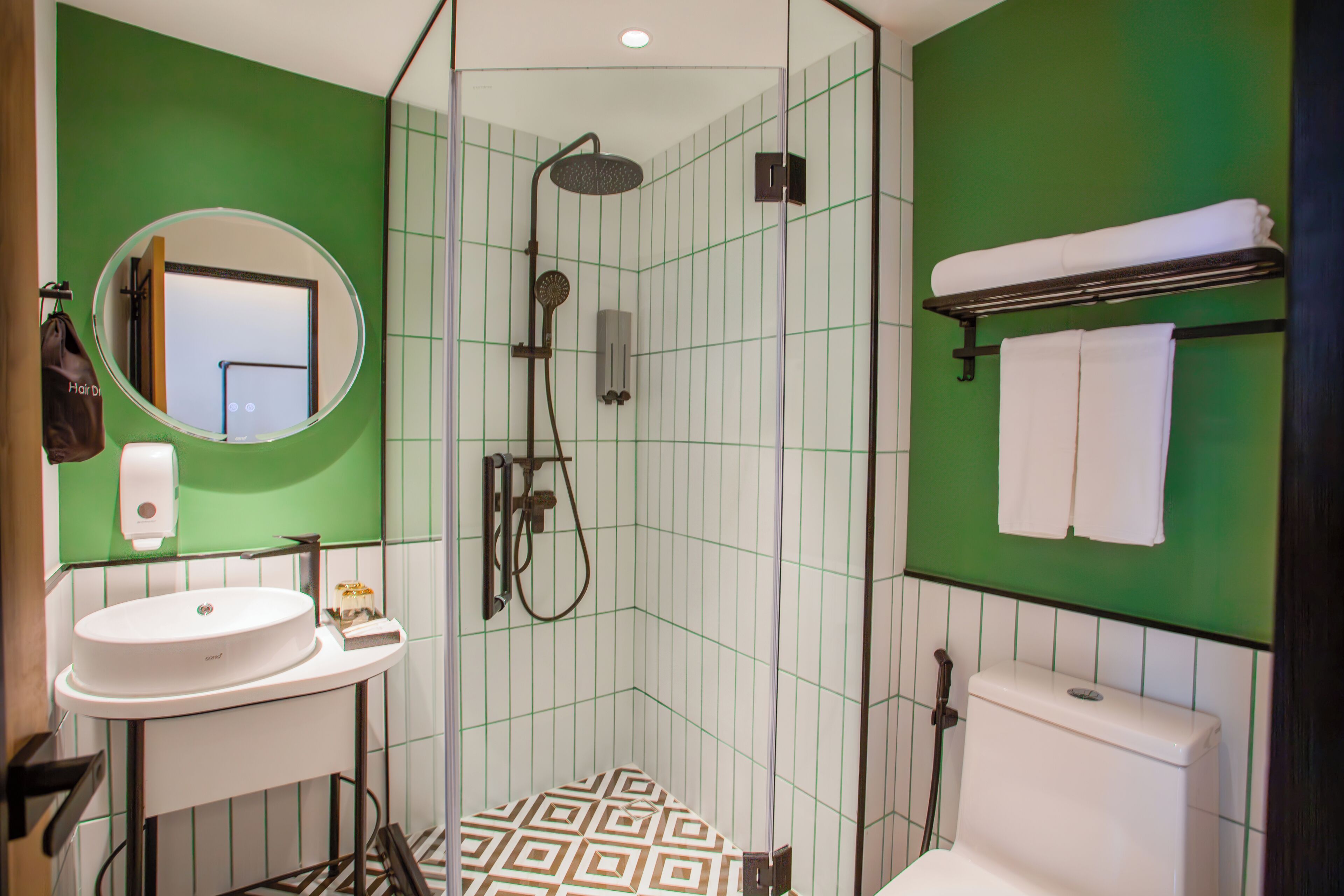 A bathroom with a shower, sink, and toilet.