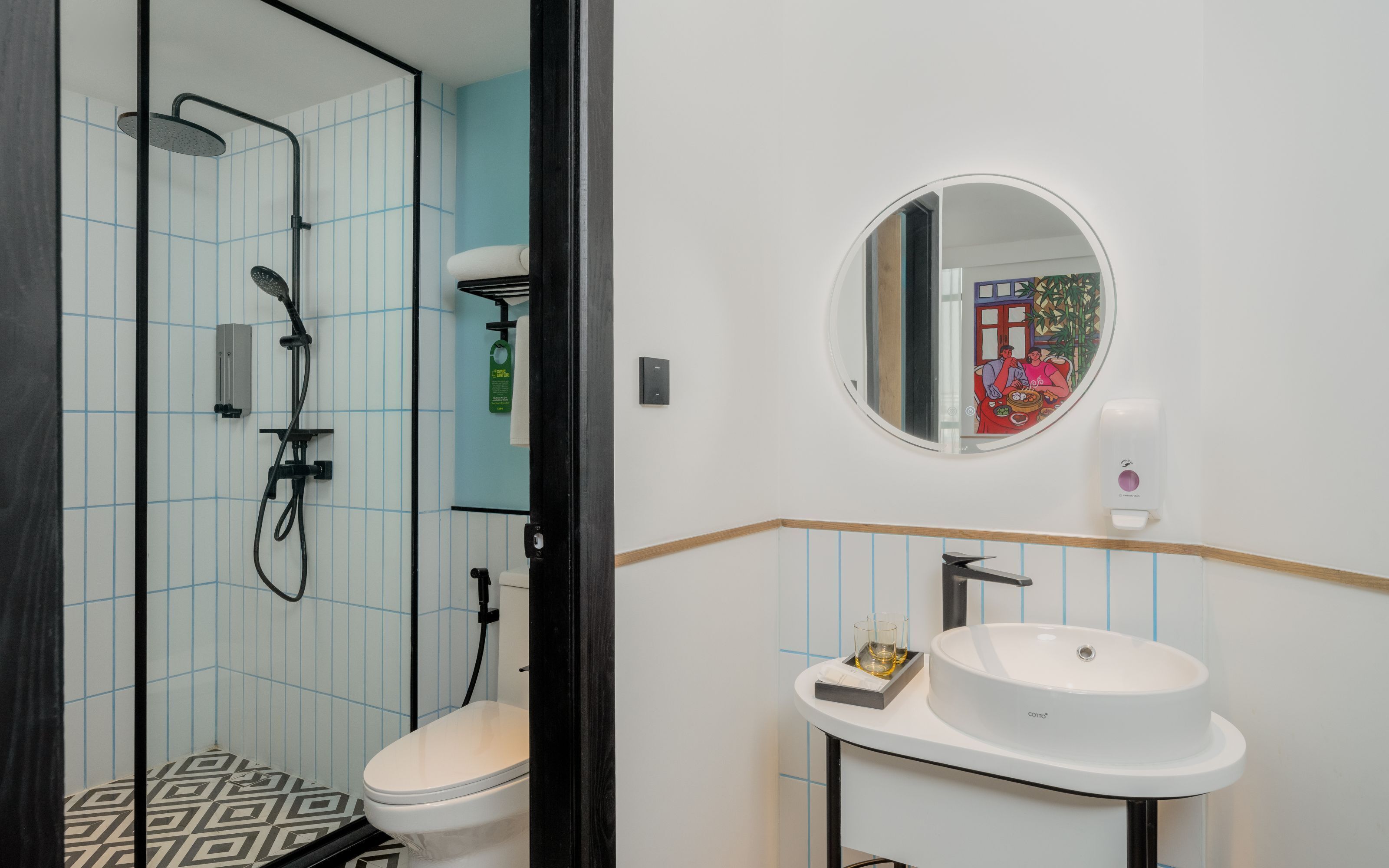 A modern bathroom with a shower, toilet, and sink.