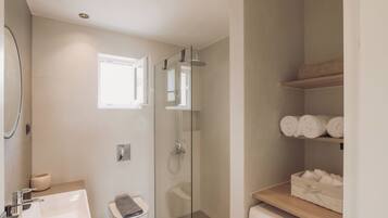 Shower, designer toiletries, hair dryer, towels