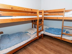 A bunk bed room with wooden frames and blue bedding. - 4 Star Holiday Home in Vestervig (Vestervig)