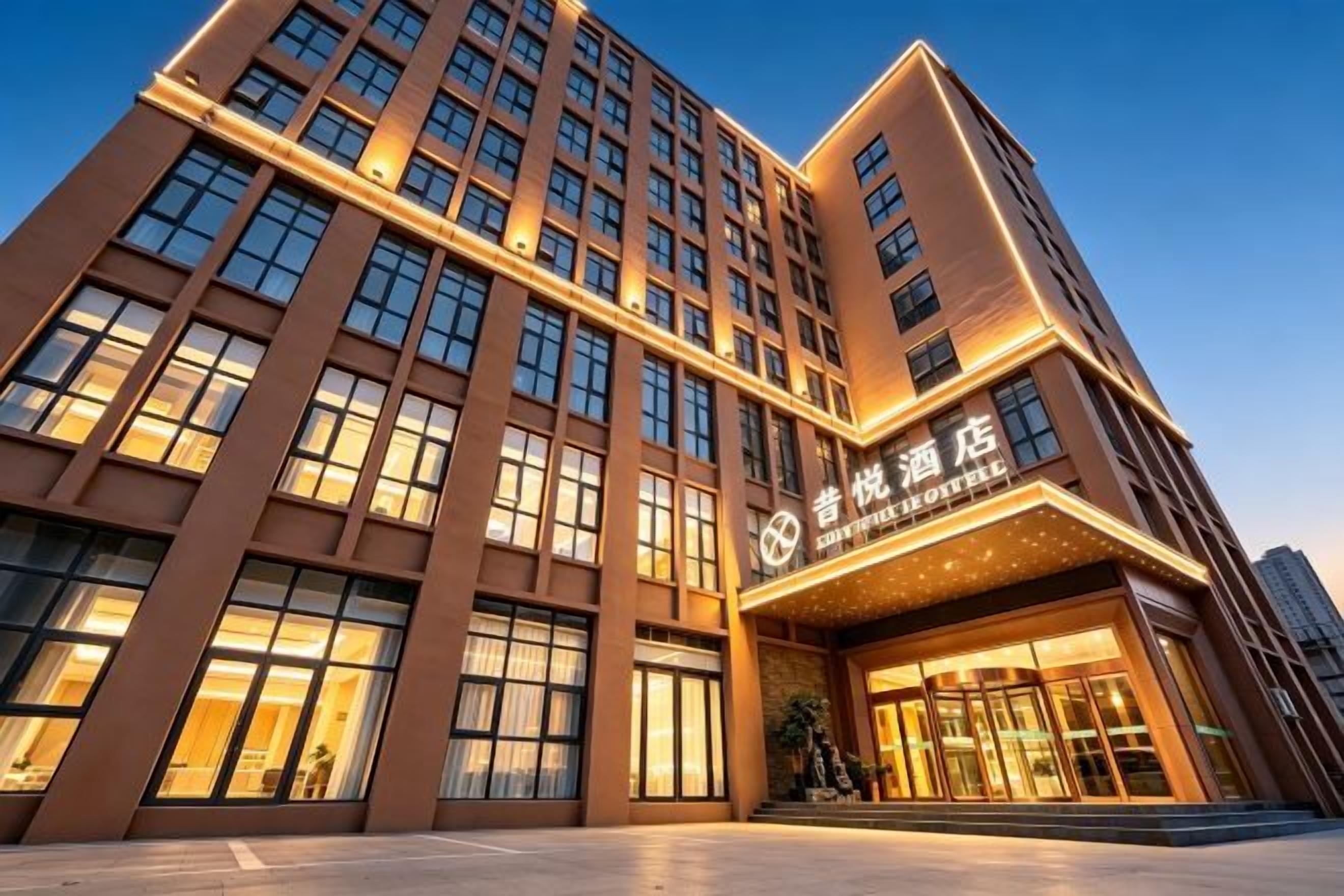 A multi-story hotel with a prominent entrance and a large glass facade.