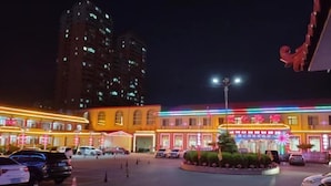 A brightly lit hotel with multiple floors and a central courtyard. - Zunhua GuestHotel (Zunhua)