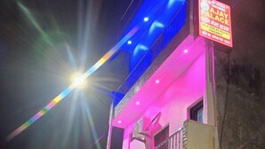 A multi-story building with balconies and a sign indicating a business named "AJAY ALACE." - Ajay Palace Home Stay (Faizabad)