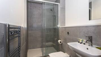 Shower, hair dryer, towels, shampoo